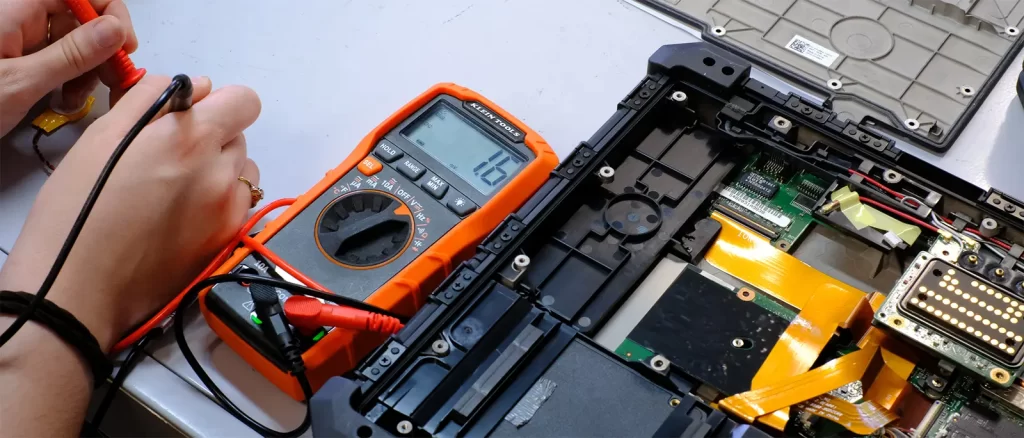 Built to Last: Why Refurbished Rugged Laptops Makes Sense 2 CMOS battery being tested inside a Dell Rugged Extreme laptop as part of Revived IT’s refurbishment process.
