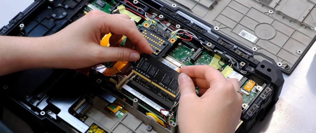Built to Last: Why Refurbished Rugged Laptops Makes Sense 3 Technician installing new memory in a Dell Rugged Extreme laptop during the refurbishment process.